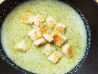 broccoli puree soup with croutons close-up