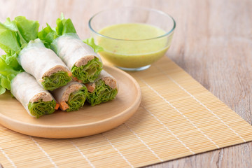 Tuna salad rolls and sauce on a wooden plate is a non-fat food for good health.