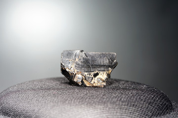 A black rock also called healing stone shungite, which consists mainly of carbon was photographed...