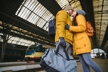 happy couple at railway station. meet after long time no see each other