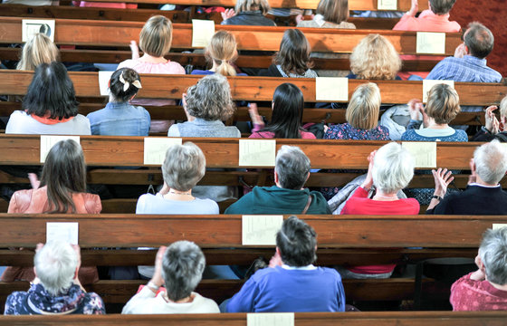 Draufsicht auf eine christliche Gemeinde bei einem Gottesdienst oder Konzert in einer Kirche &acirc;&euro;&ldquo; selektiver Fokus, Bewegungsunsch&Atilde;&curren;rfe beim Klatschen