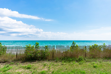Fototapeta premium Lake Michigan Shoreline with Fence in Evanston Illinois during the Summer