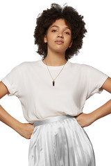 The medium front shot of a young mulatta lady with a golden chainlet with a pendant in the form of screw with a fitted-in dark gemstone similar to a black onyx on her neck.  © RedUmbrella&Donkey
