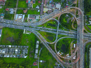 Aerial top view of Toll expressway, Motorway shaped like a triangle or heart, Modern transportation, Multilevel junction highway, Road traffic an important infrastructure in Thailand.