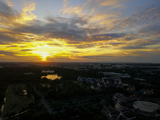Beautiful sunset sky above the city with sky blue and orange light of the sun through the clouds in the sky, Orange and red dramatic colors, Warm color - Image