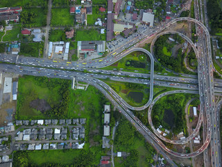 Aerial top view of Toll expressway, Motorway shaped like a triangle or heart, Modern transportation, Multilevel junction highway, Road traffic an important infrastructure in Thailand.