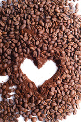 heart made of coffee beans and gronded coffe