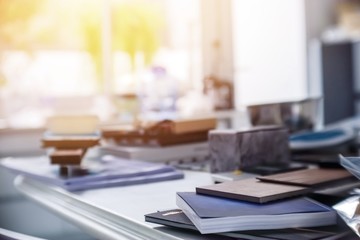 Books on the table in the room with sunlight and blurred background , study education work reference concept.