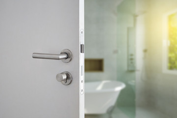 Door handle , door open in front of blur interior room background, selective focus