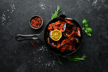 Mussels cooked in tomato sauce. Seafood. Top view. Free space for your text.