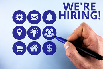 Fototapeta premium Conceptual hand writing showing We Re Hiring. Concept meaning recently employ someone or pay someone to do particular job Male designing layout presentation concept for business promotion