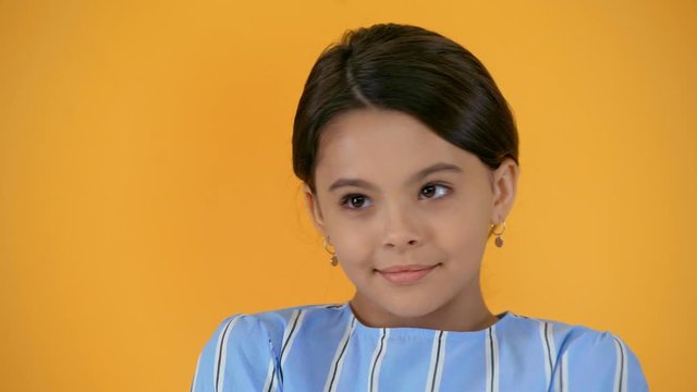 shy smiling preteen kid isolated on yellow