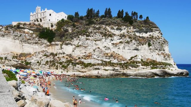 Overview of the beach and the promontory with the church above symbol of Tropea city - Real tim in 4K