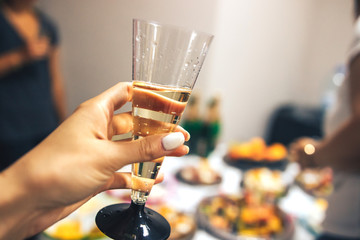 Celebration. Female hand with a glass of champagne