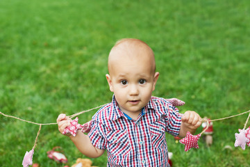 Family Christmas in July. Portrait of little boy near christmas tree. Baby decorating pine. Winter holidays and people concept. Merry Christmas and Happy Holidays Greeting card. Christmas child.  