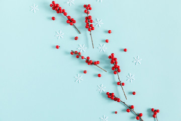 Christmas modern composition. Red berries on pastel blue background. Christmas, New Year, winter concept. Flat lay, top view, copy space