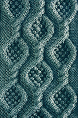 vertical background texture knitted canvas with aran patterns close up in turquoise color