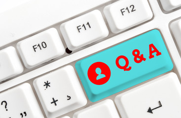 Conceptual hand writing showing Q And A. Concept meaning defined as questions being asked and answers White pc keyboard with note paper above the white background