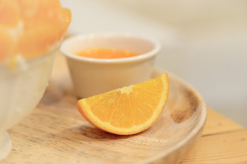 A piece of orange in dessert recipe, soft and selective focus.