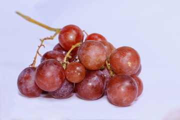 Fototapeta premium fresh purple grapes put down on white