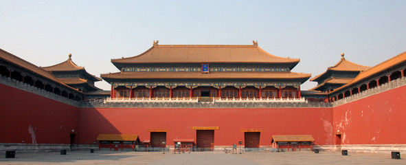 Forbidden City, Beijing, China. The entrance to the Forbidden City has a sign saying 'Meridian Gate'. Entrance signs are Chinese with English translations. The Forbidden City has Chinese architecture.