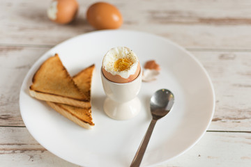 Hard boiled egg and bread sandwich with sprouted grain on a wooden table. Traditional food for healthy breakfast.