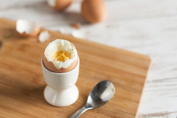 Hard boiled egg and bread sandwich with sprouted grain on a wooden table. Traditional food for healthy breakfast.