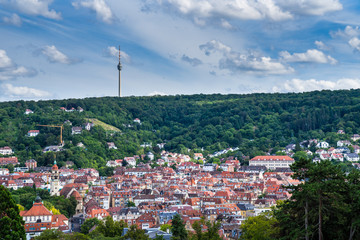 Germany, Cityscape stuttgart of red roofs of houses in basin surrounded by green forest and...