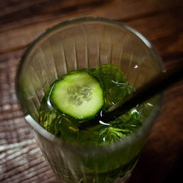 cucumber lemonade in glass with straw