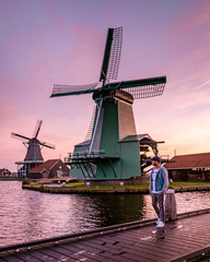 men watching Sunrise at the Zaanse Schans windmill village in the Netherlands, zaanse schans is a small wooden house village in Holland, Dutch windmills