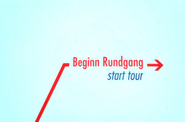 Text start tour with red arrow isolated on white background.