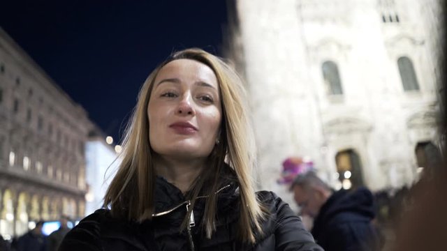 Young woman taking selfie photo by Duomo Cathedral in Milano