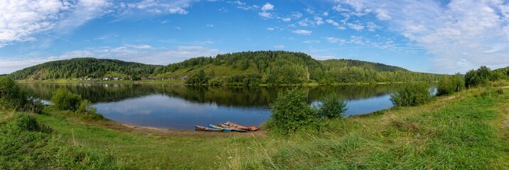 Fototapeta na wymiar Vishera river, on the opposite banks of the village Bahakri. Krasnovishersk, Perm Krai, Russia