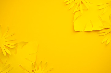Top view mix of paper palm leaves on yellow background. Summer frame concept. Flat lay mockup with copy space