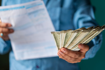 Businessman Paying Various Bills