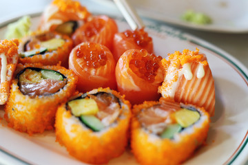 Close-up orange color Salmon Sushi on White Plate.