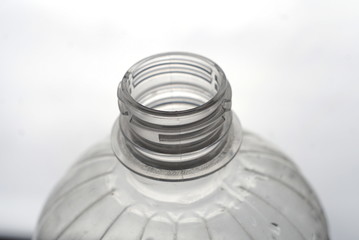 open plastic bottle on light background close up           