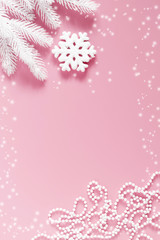 Christmas modern composition. White fir branches, snowflake, Xmas decorations on pastel pink background. Christmas, New Year, winter concept. Flat lay, top view, copy space