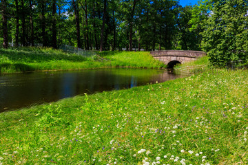 Stone arch bridge across a small river in Catherine park in Pushkin (Tsarskoye Selo), Russia