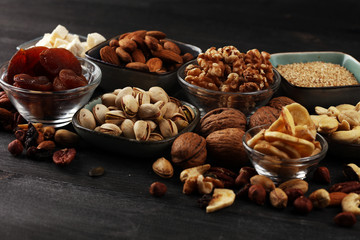 Composition with dried fruits and assorted healthy nuts on rustic background