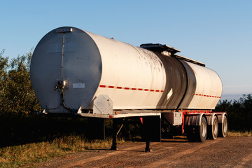 Fototapeta na wymiar Parked semi-truck asphalt tanker trailer with high contrast vintage look.