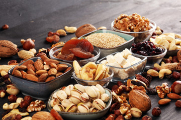 Composition with dried fruits and assorted healthy nuts on rustic background