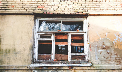 Windows with broken glass of an abandoned building