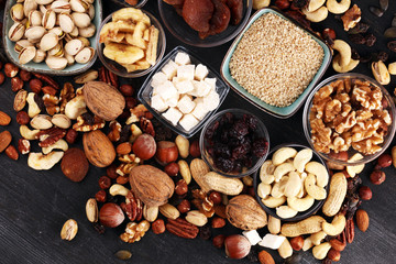 Composition with dried fruits and assorted healthy nuts on rustic background