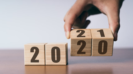 New year 2020 change to 2021 concept, hand change wooden cubes