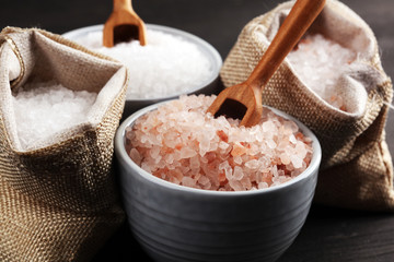 Sea salt and himalayan in burlap. Crystals of salt on dark background