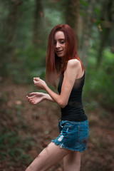 a skinny redhead girl in a brazilian forest