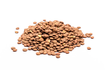 Isolated stack of uncooked lentils on white background from above.