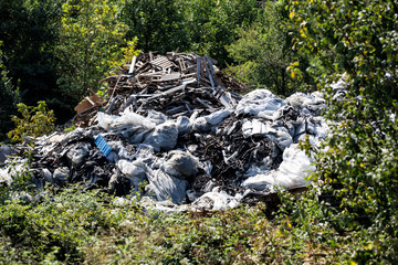 environmental pollution in nature, car and machinery parts and garbage thrown into the nature.