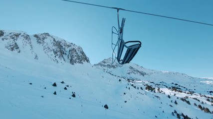 Riding ski chair lift on sunny winter day